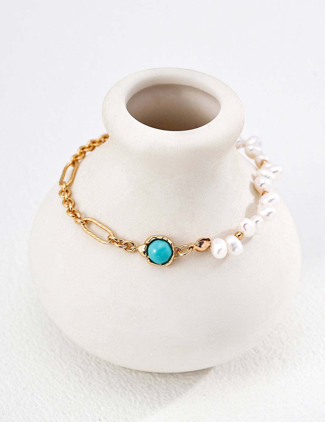 A professional studio photo of the Holly bracelet, highlighting the contrast between the natural petite pearls and the smooth turquoise beads.